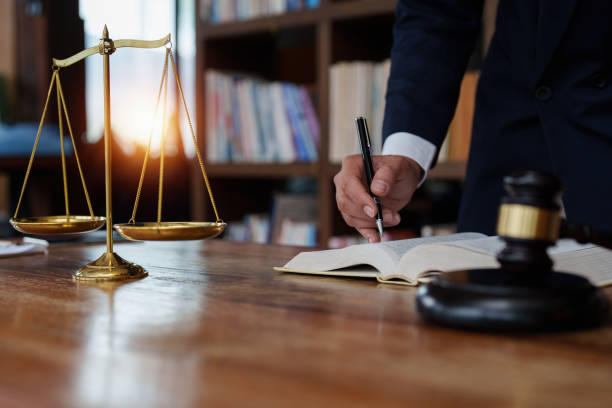 Close up lawyer businessman working or reading lawbook in office workplace for consultant lawyer concept