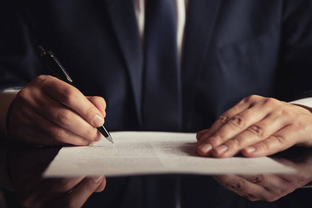 Notary working in office. Lawyer, attorney, business person signing a contract, working in office